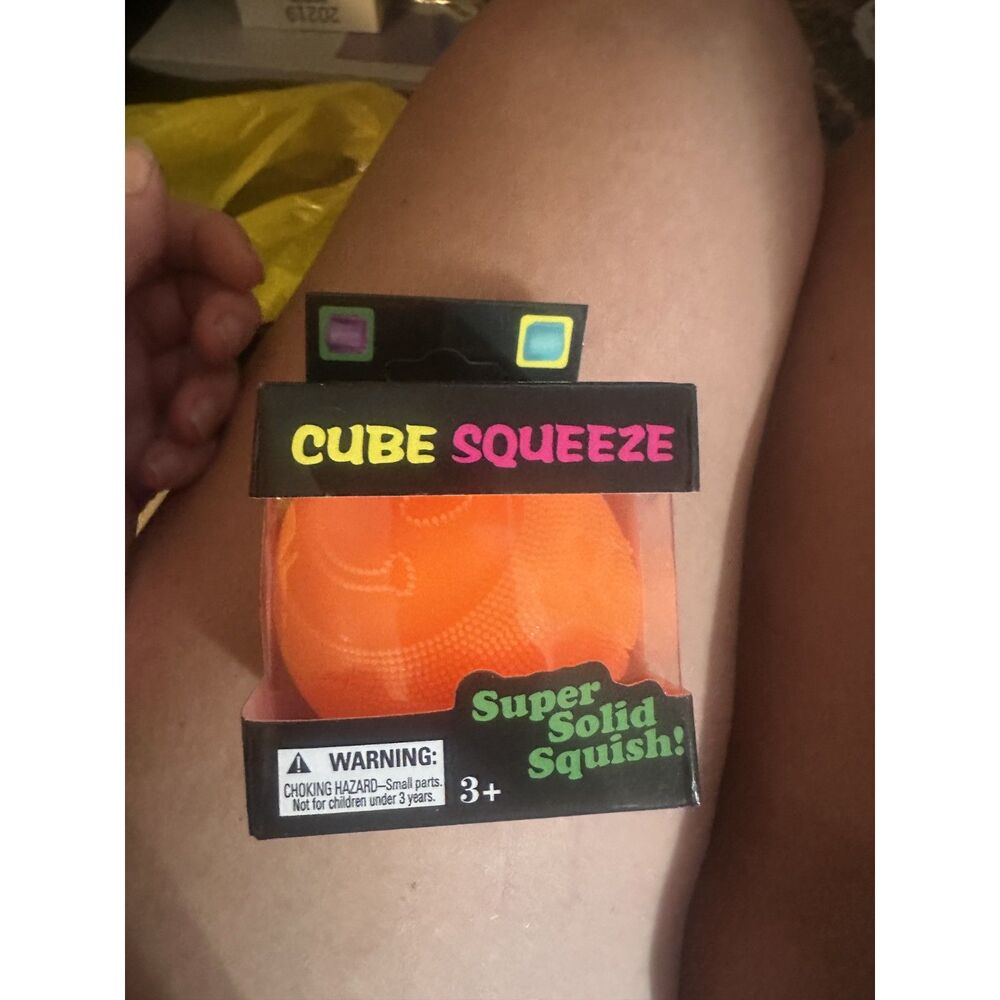 Cube Squeeze "Super Solid Squish" textured sensory ball in orange